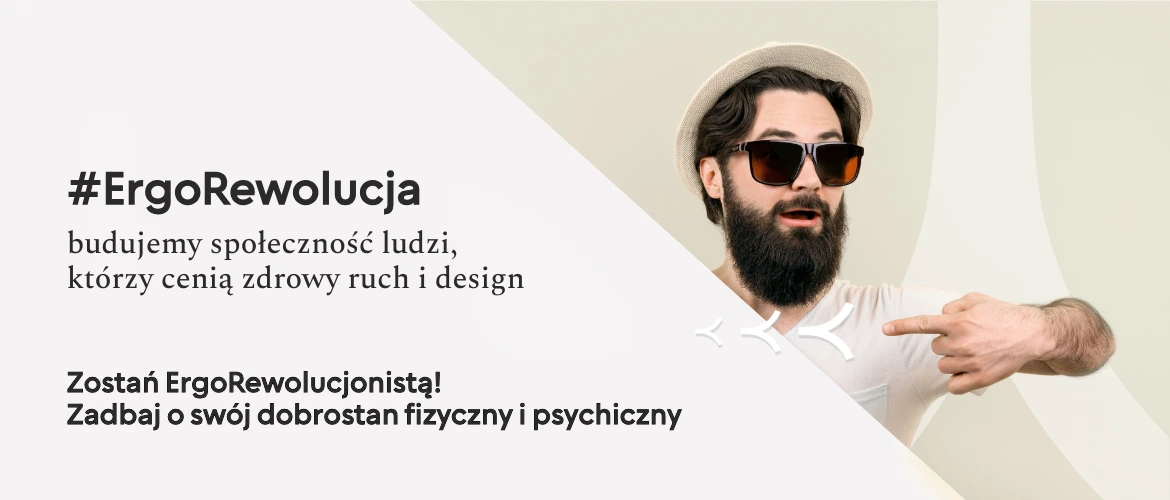 Młody mężczyzna z zarostem, w kapeluszu i okularach przeciwsłonecznych promuje #ErgoRewolucję Kenoko: budujemy społeczność ludzi, którzy cenią zdrowy ruch i design.